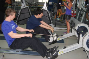 APEX participant and trainer using rowing machines together