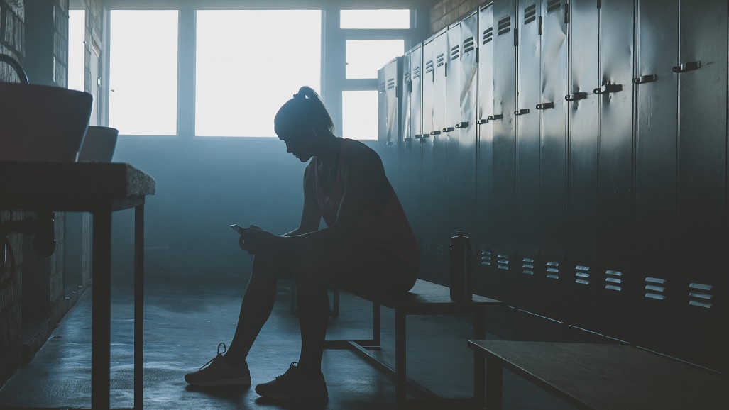 emale athlete preparing for a workout in a gym locker room